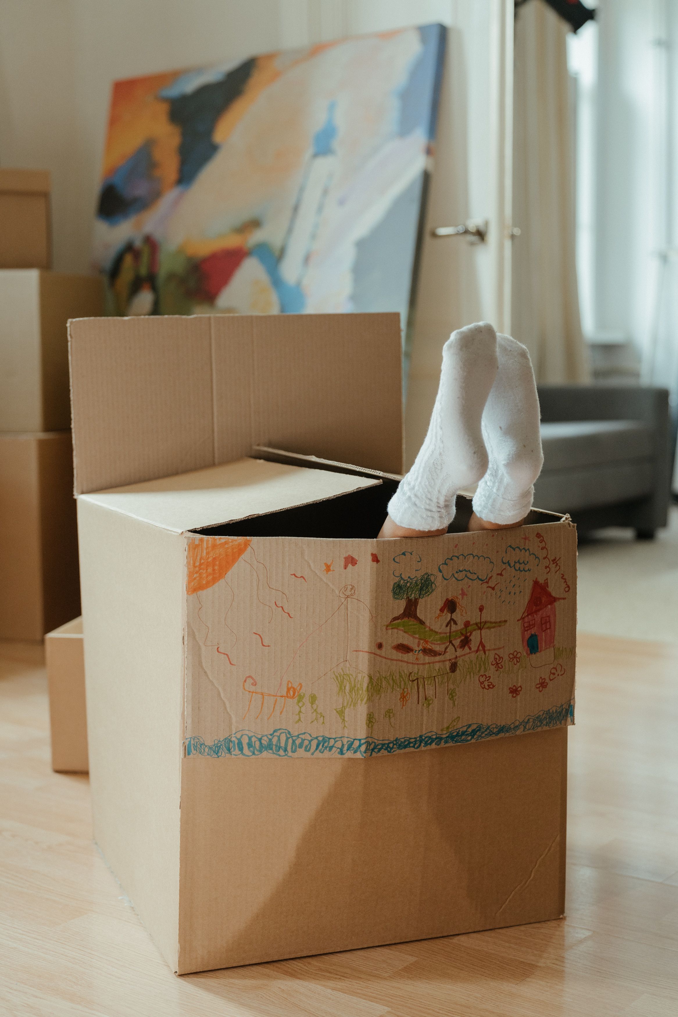 Packed moving boxes in a living room ahead of settlement day